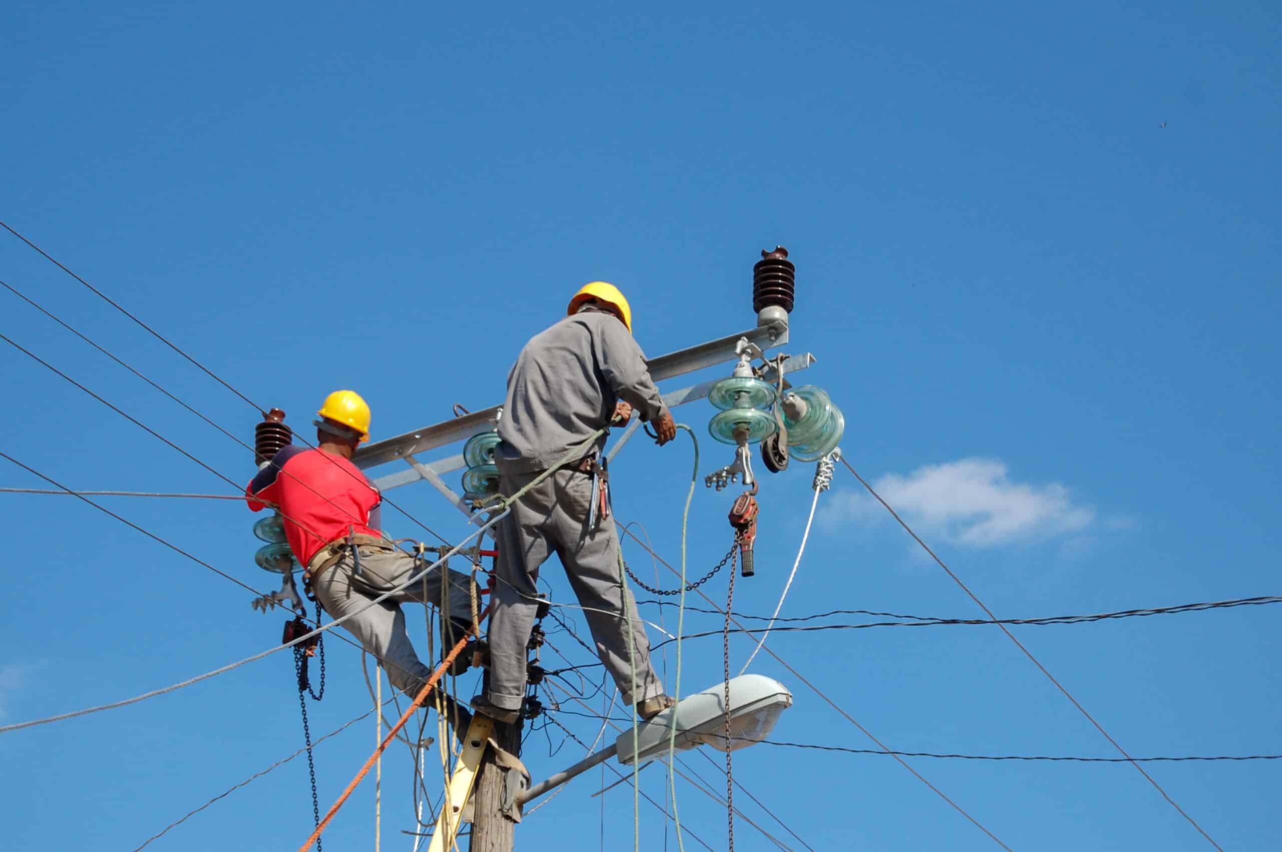 Lineman working on a utility pole in protective equipment