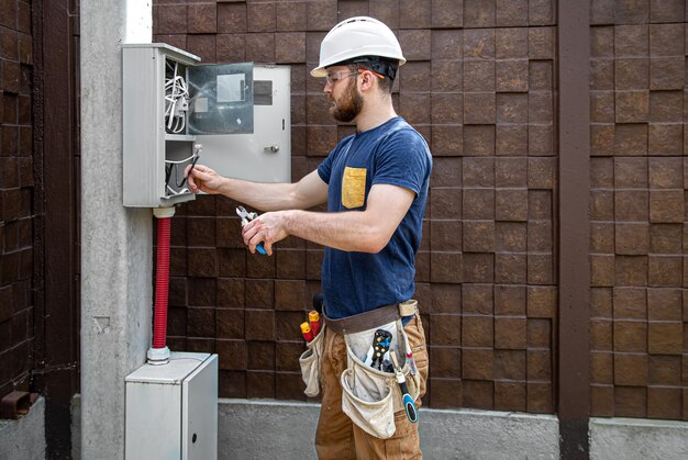 Experienced electrician working in a switchboard — Second Act Trades