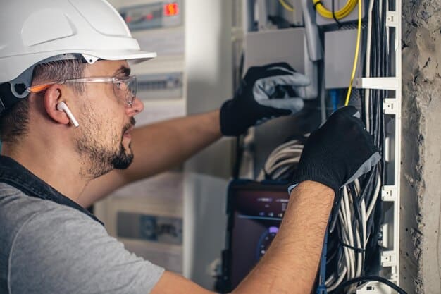 Electrician working in a switchboard
