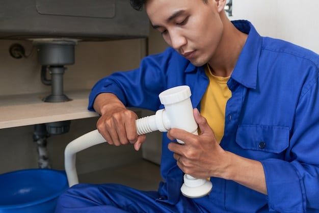 Plumber repairing pipes under a sink — Second Act Trades