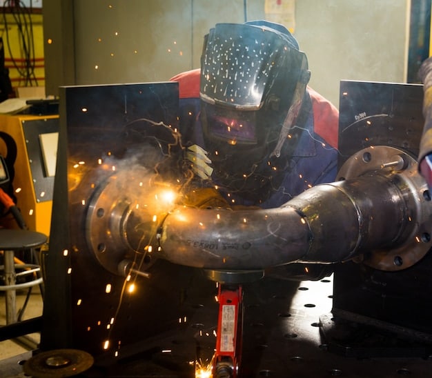 Welder working with steel in a workshop