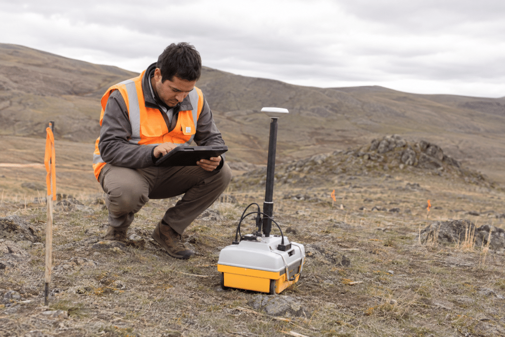 Geophysical technician conducting a field survey with measurement equipment